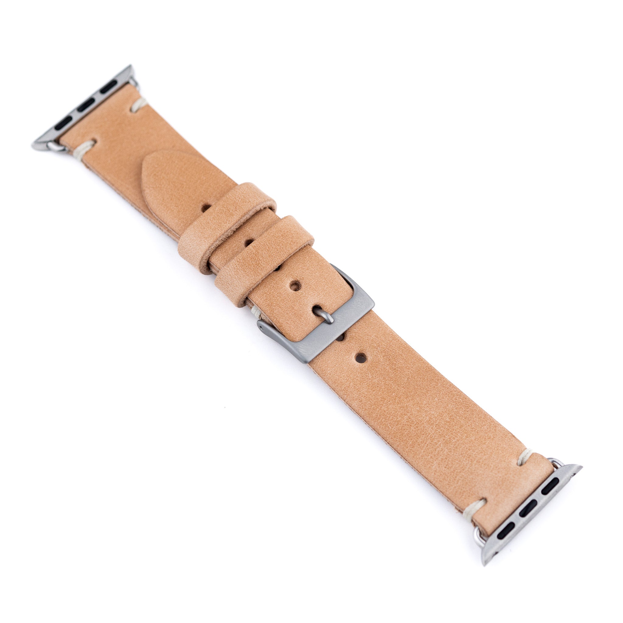 Tan leather watch strap with silver buckle on a white background