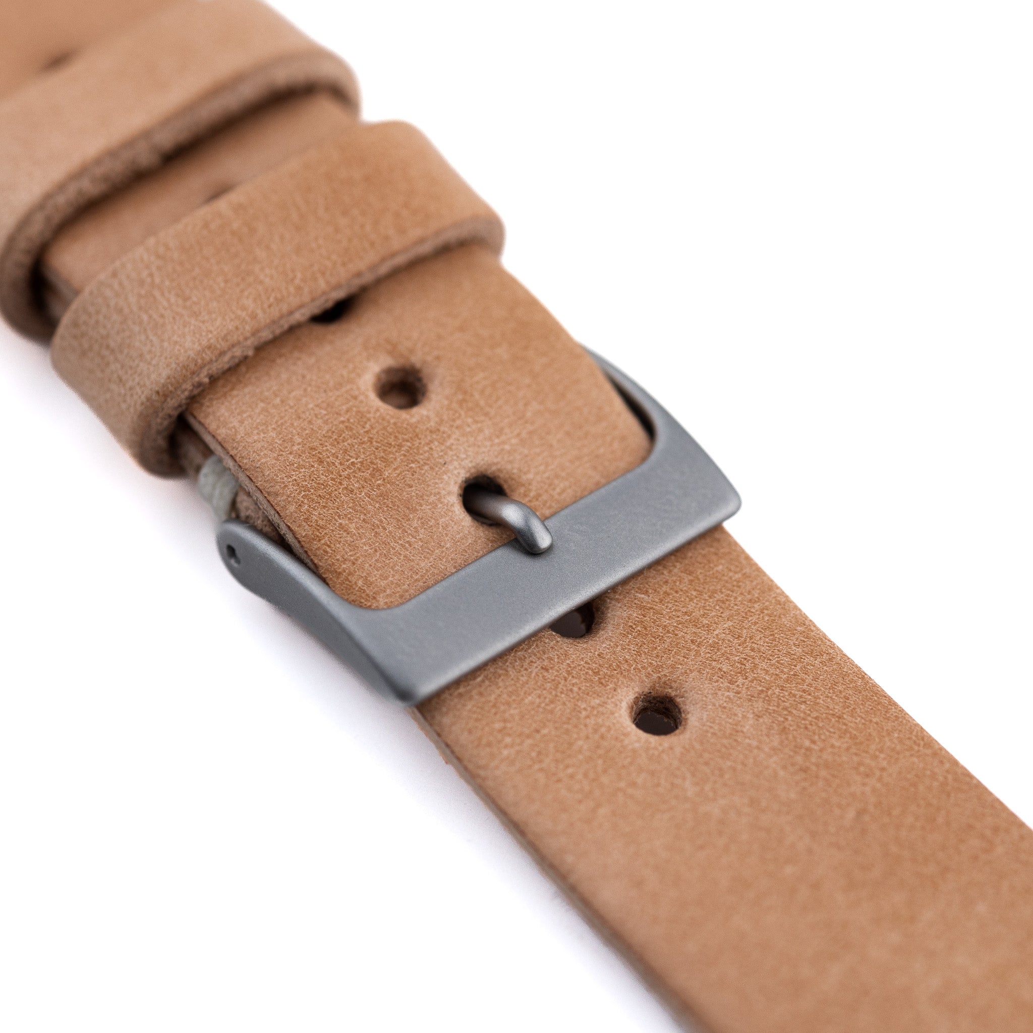 Brown leather watch strap with a silver buckle on a white background