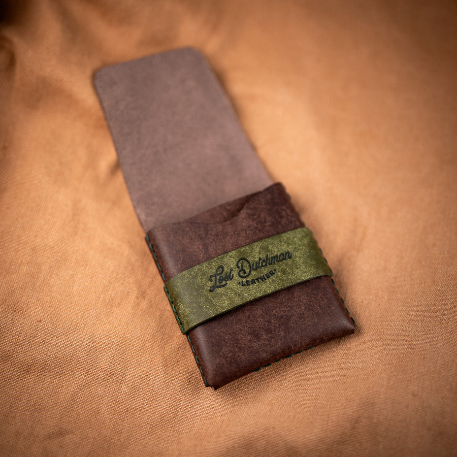 Brown leather wallet with an olive green wrap band
