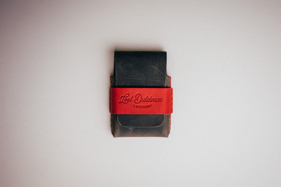 Black leather wallet with a red wrap band