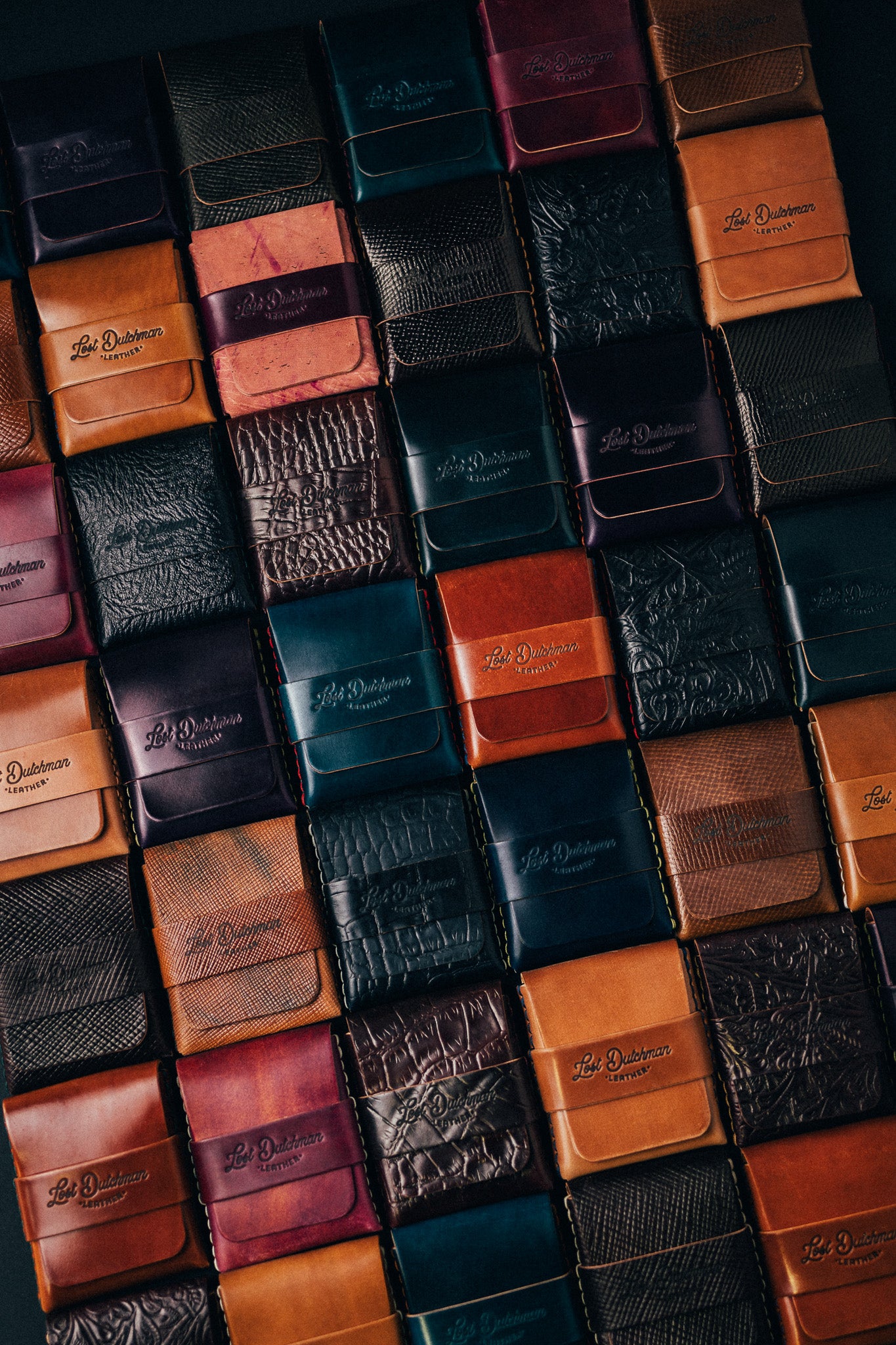 Grid of folded leather wallets in assorted colours