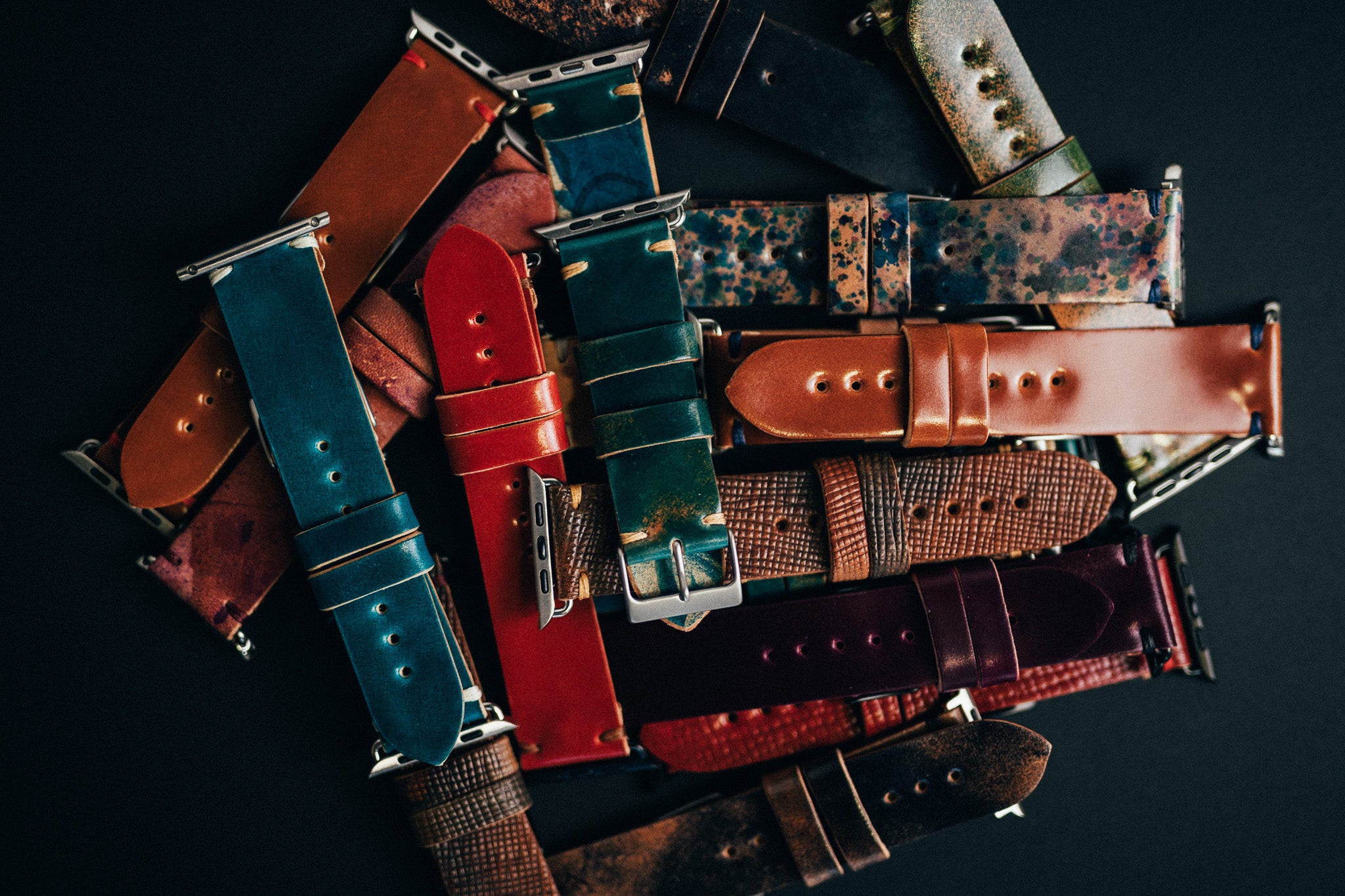 Assorted colourful leather watch straps and belts