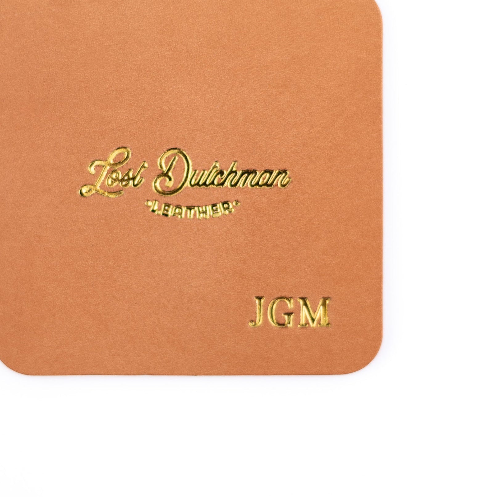 Brown leather wallet with 'Lost Dutchman' branding and initials 'JGM'