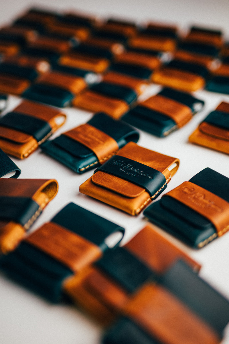 Rows of dark teal and brown leather card holders