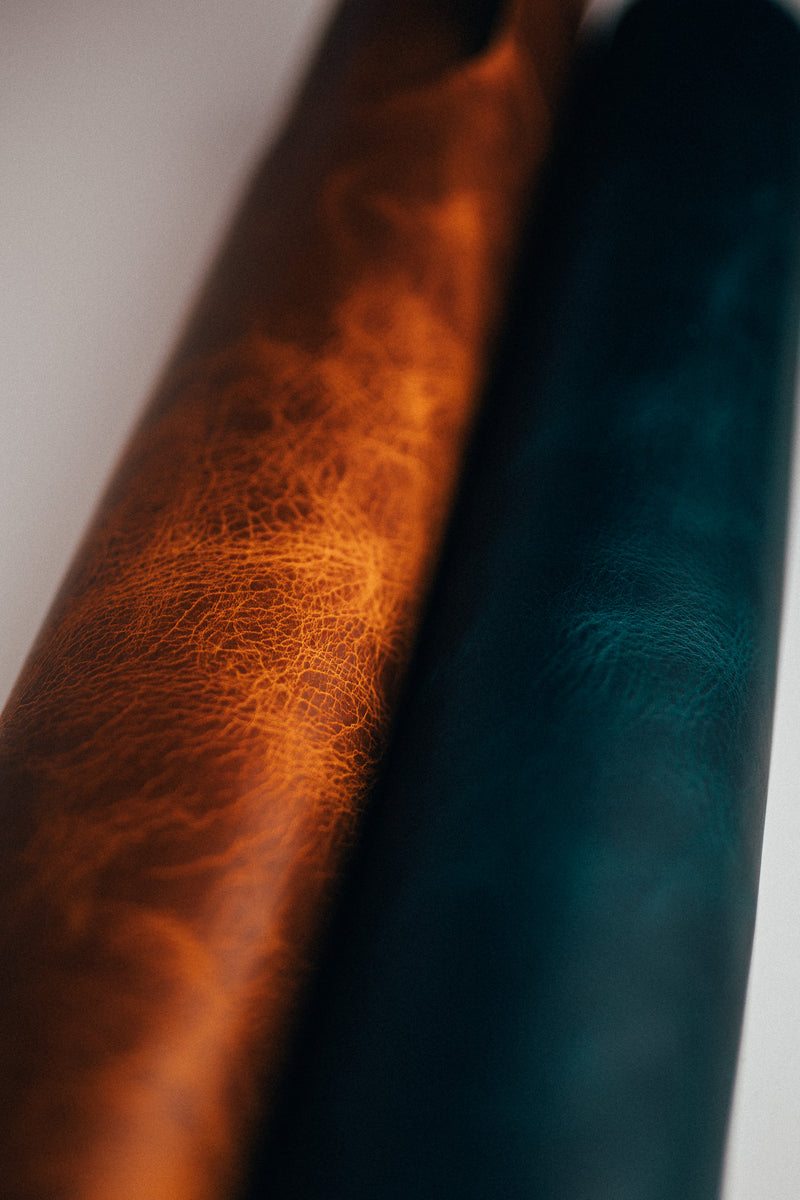 Close-up of brown and dark teal leather hides