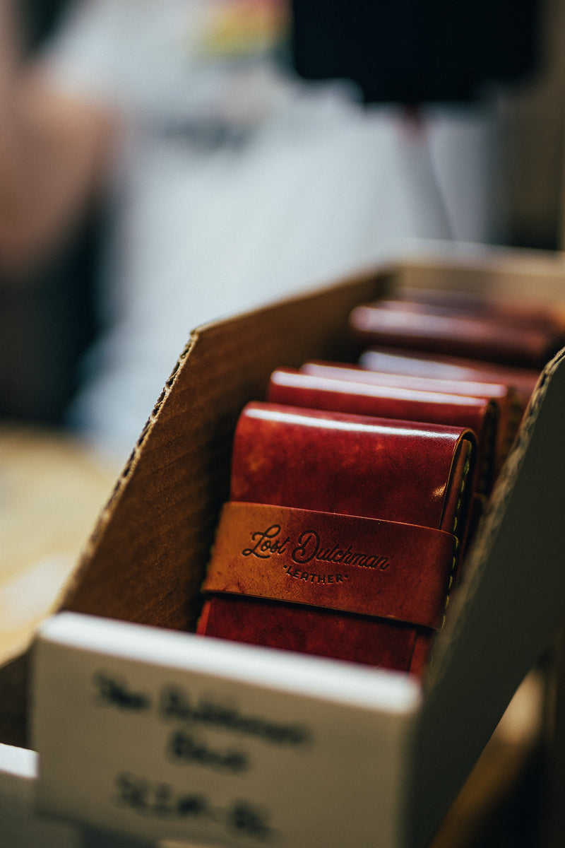 Red leather wallets standing in a cardboard display box