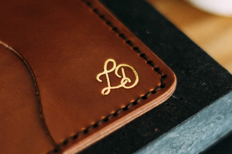 Add gold foiling on monogram and logo